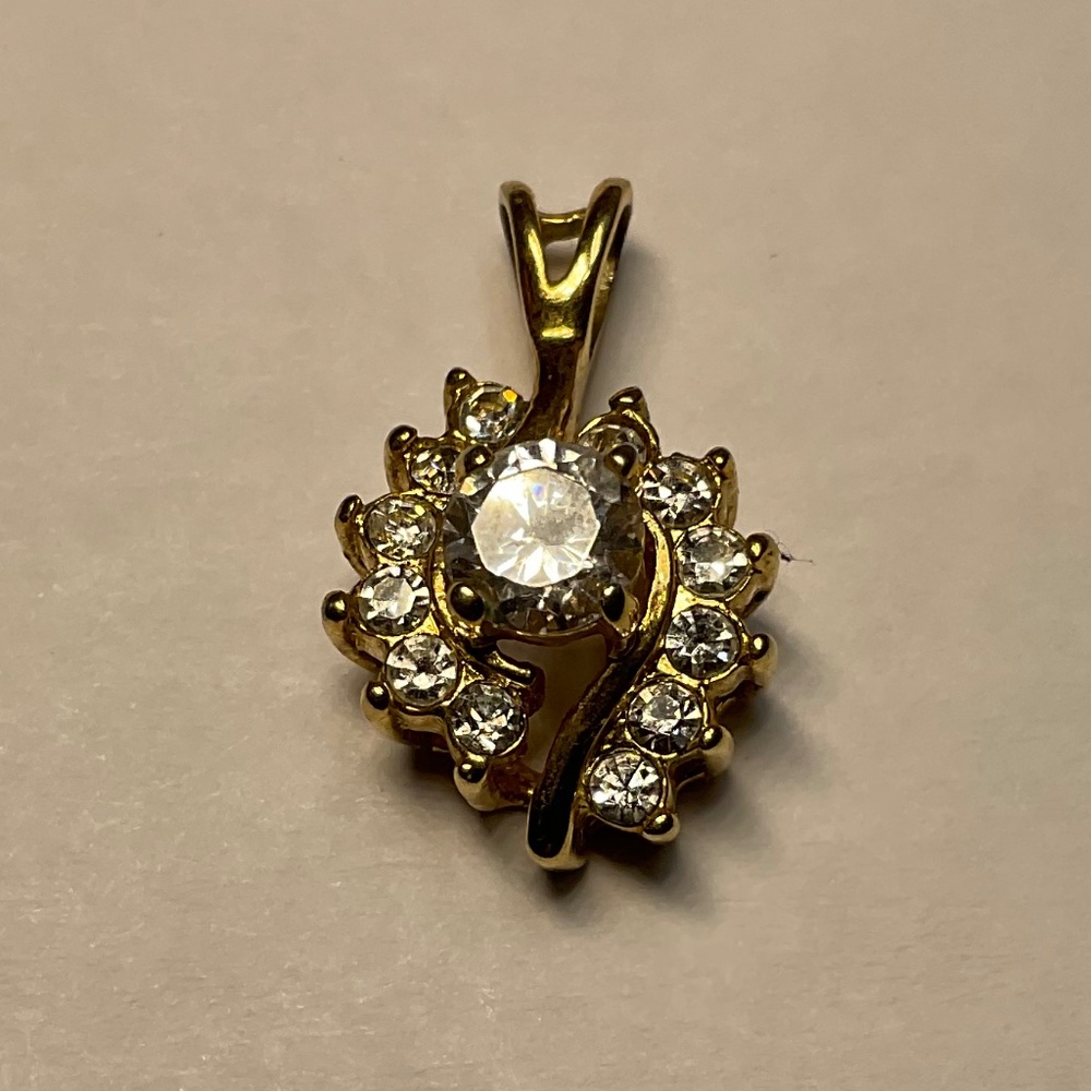 Gold Plated Pendant with clear stones. 7/8 inches long and comes with a chain